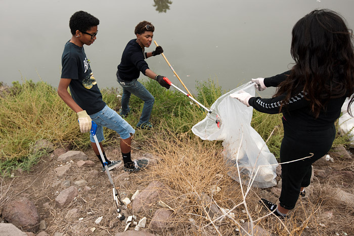 Serra High School students work the bank of the channel.