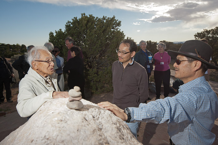 Bill Nishimura (left), former inmate of the Santa Fe Internment Camp, talks with historian, Koichiro Okada (center) at the historical marker overlooking the former prison site.