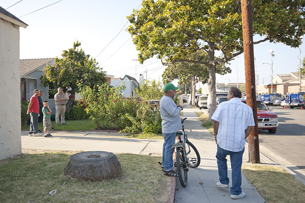 Bell residents living across the street from the civic center survey the commotion from their front yards.