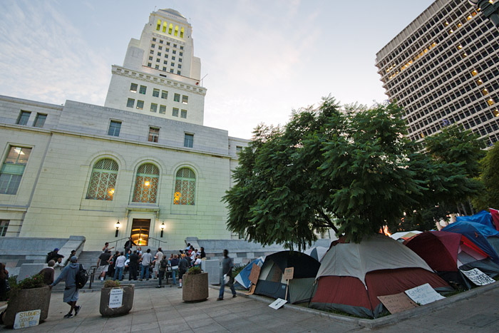 The thirty day old tent city wraps around the west and north sides of the building.